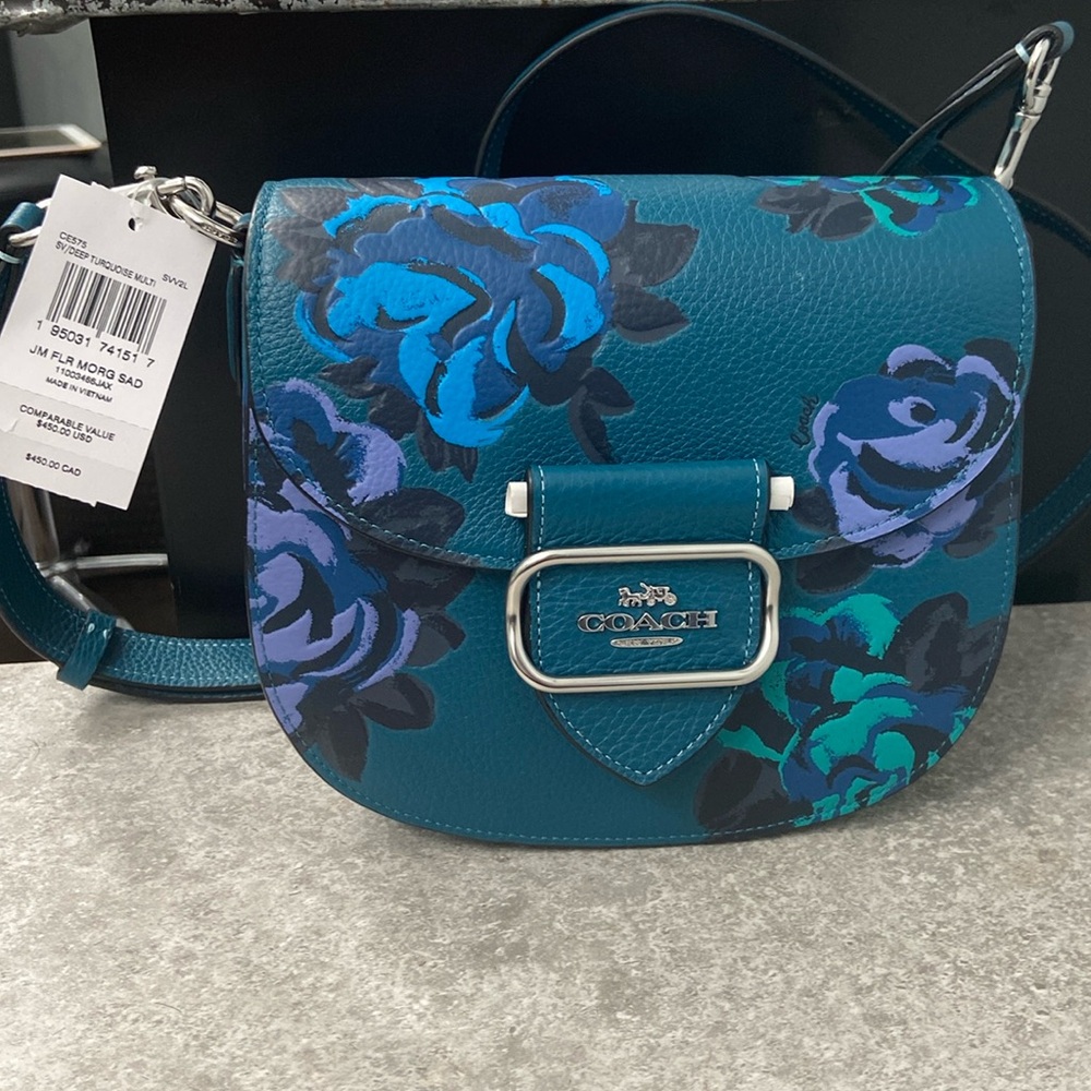 TEAL COACH MORGAN SADDLEBAG WITH JUMBO FLORAL PRINT.